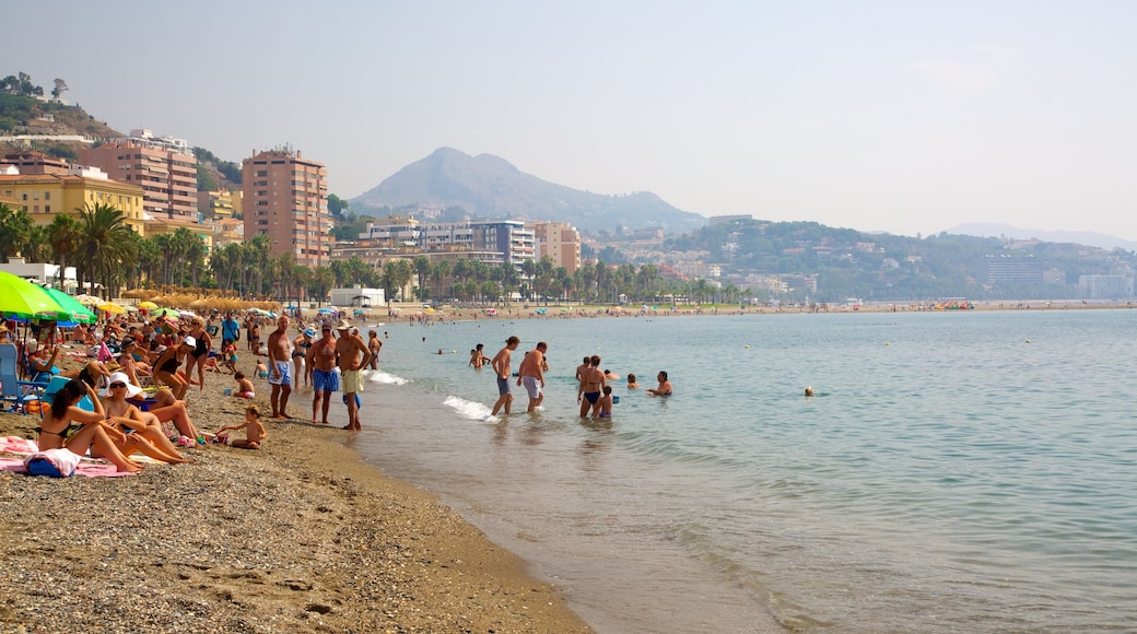 Malagueta Beach featuring a beach, swimming and a coastal town