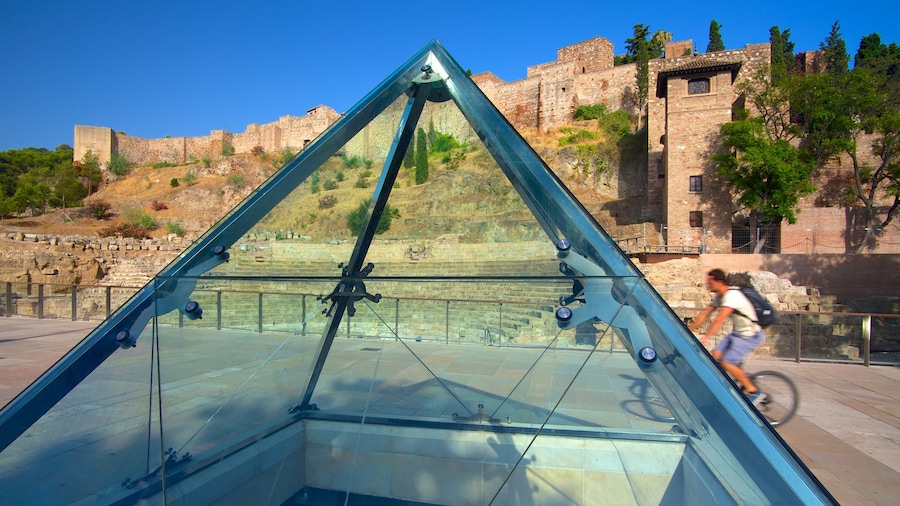 Malaga Amphitheatre which includes heritage architecture and cycling as well as an individual male