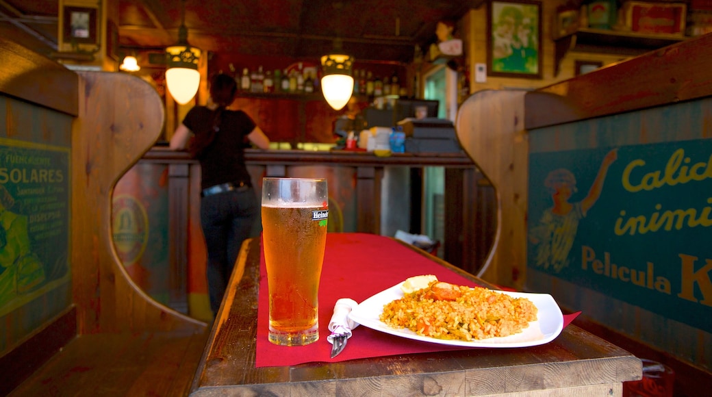 Malvarrosa Beach featuring a bar, food and interior views