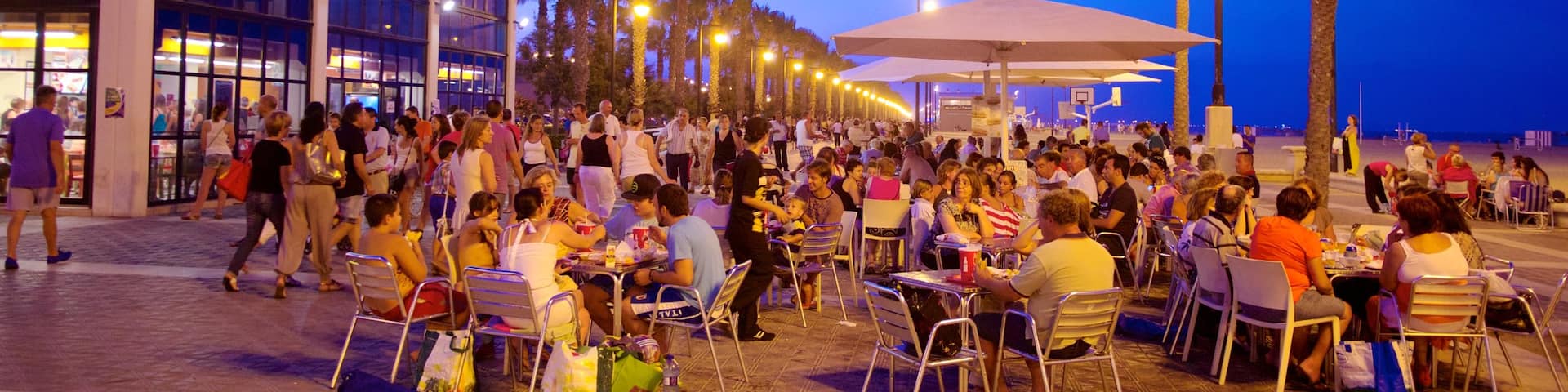 Malvarrosa Beach which includes a city, a sandy beach and outdoor eating