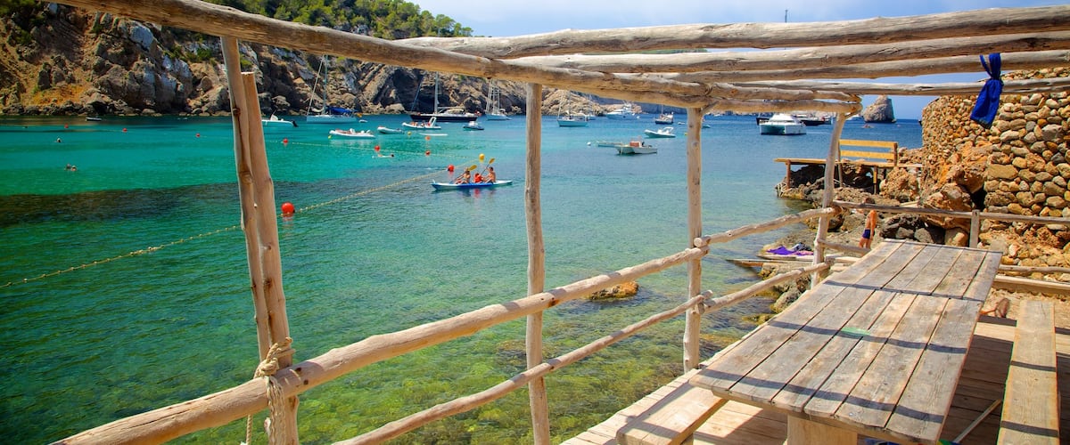 Benirras Beach showing rugged coastline and boating