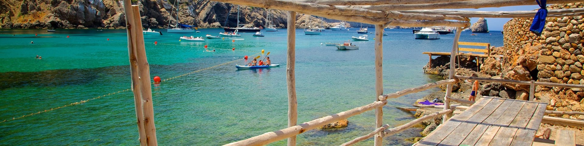 Benirras Beach showing rugged coastline and boating
