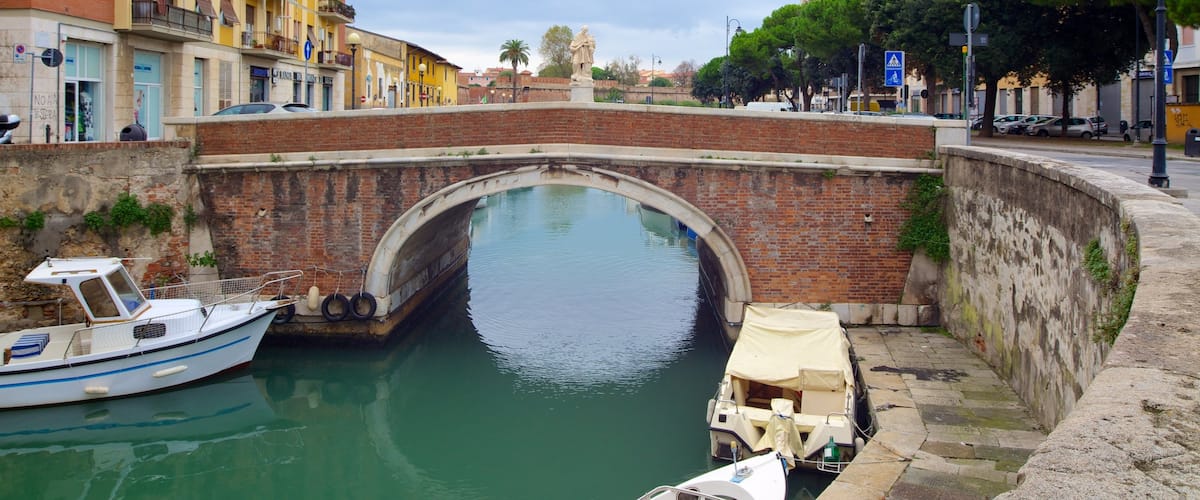 Livorno showing a river or creek, a bridge and street scenes