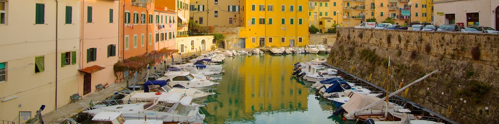 Piazza della Repubblica which includes a river or creek, a city and boating