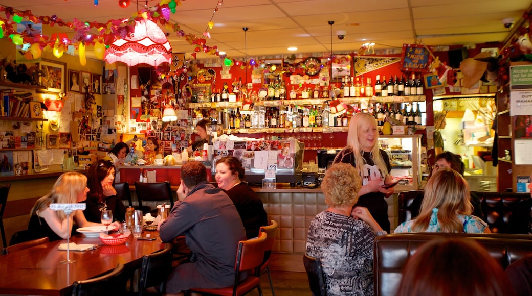 Courtenay Place featuring a bar and interior views as well as a small group of people