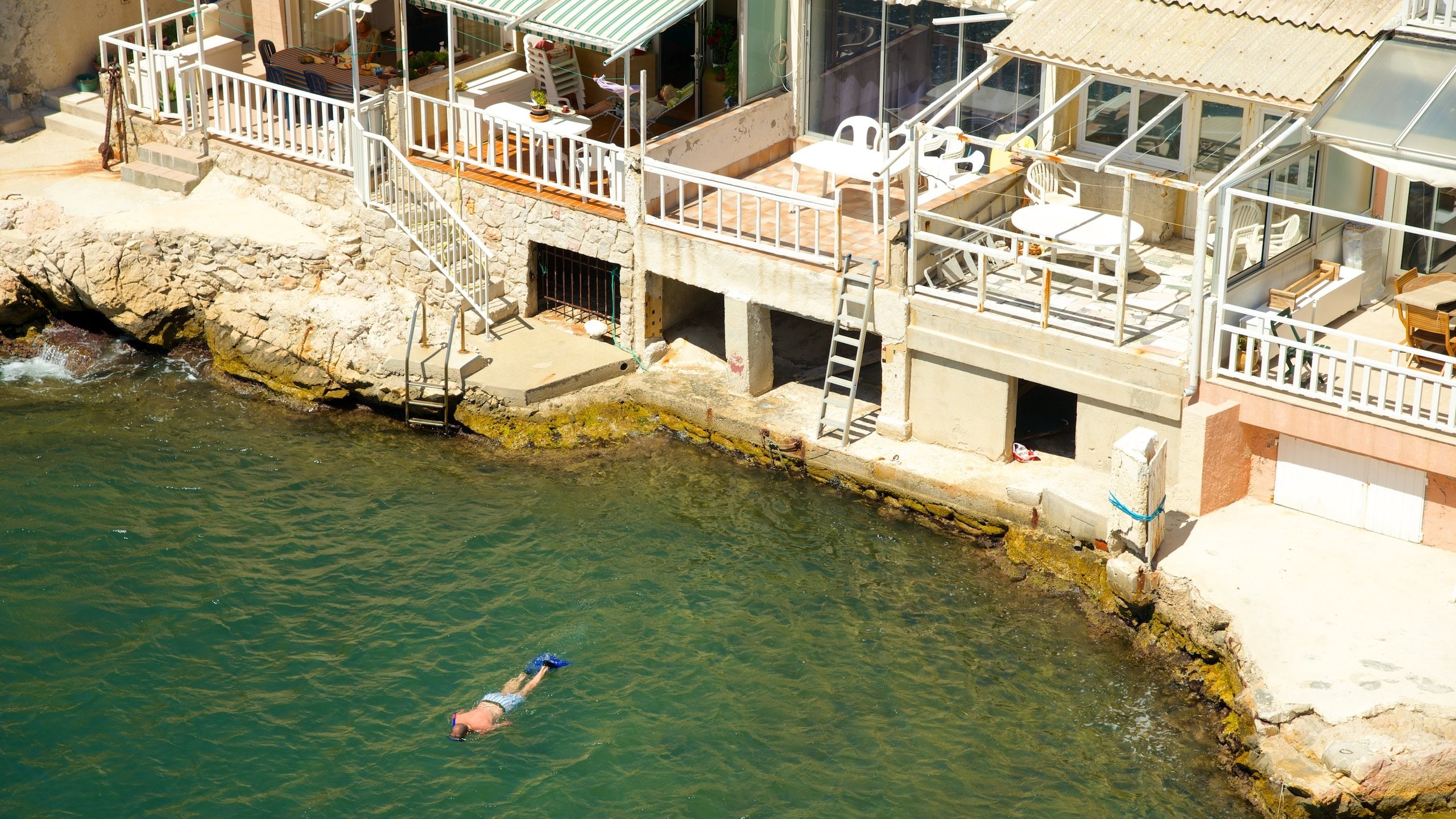 Marseille showing a coastal town, snorkeling and rocky coastline