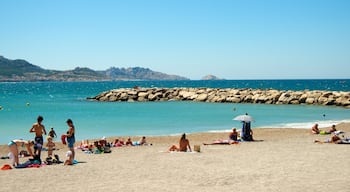 Spiaggia Prado mostrando vista della costa e spiaggia sabbiosa cosi come un piccolo gruppo di persone