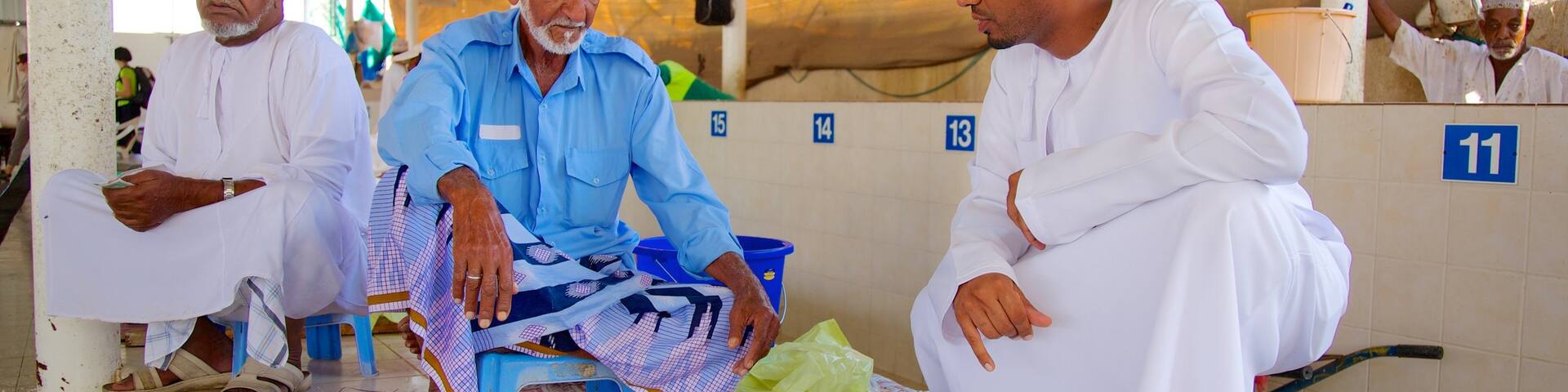 Mutrah Fish Market featuring interior views, food and markets