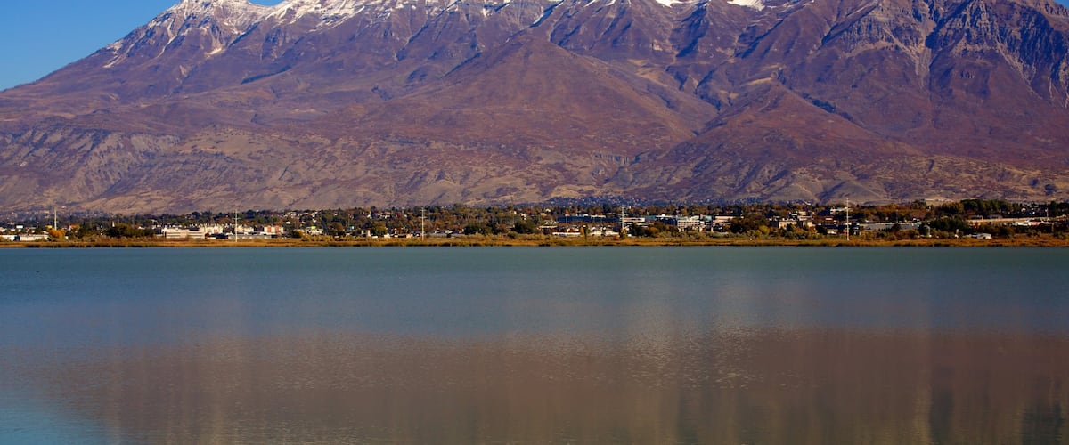 Utah Lake State Park featuring mountains, a lake or waterhole and a park
