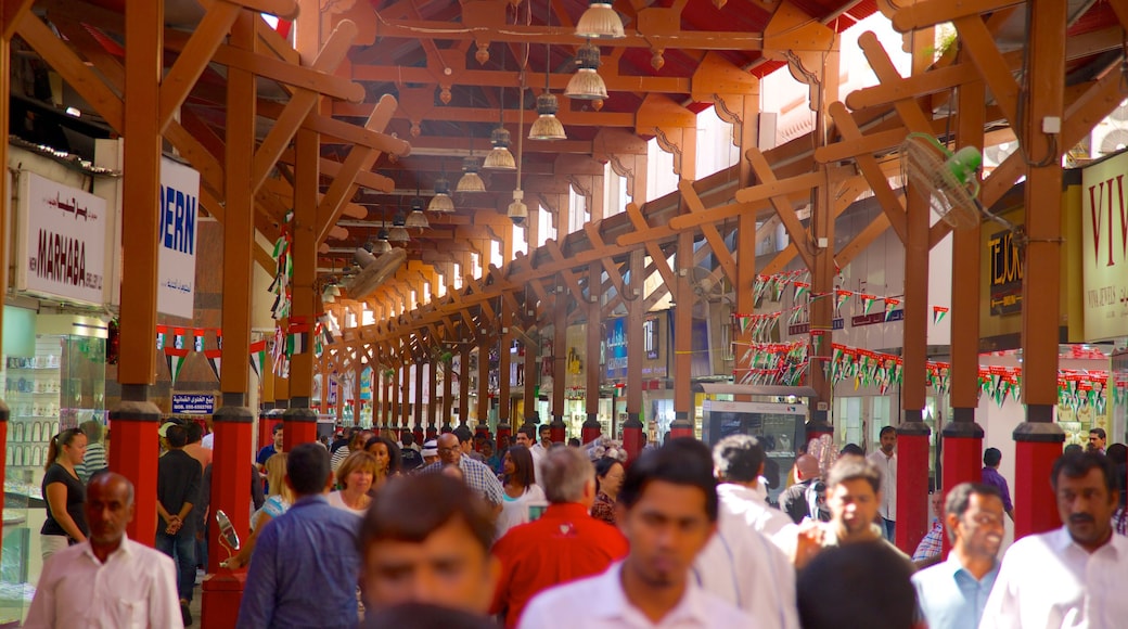 Gold Souk featuring interior views as well as a large group of people