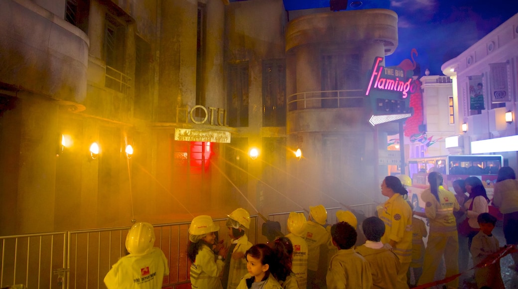 Dubai Mall showing signage and a city as well as a large group of people