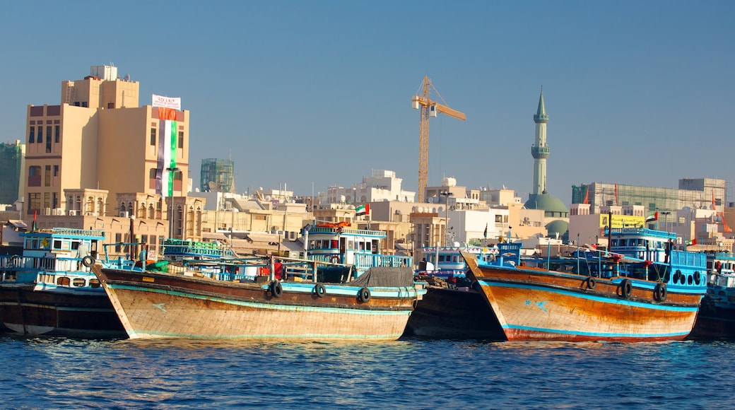 Dubai Creek showing a bay or harbour, a coastal town and boating