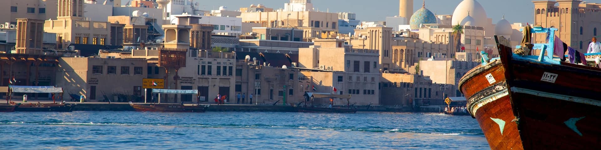 Dubai Creek showing boating, central business district and a city