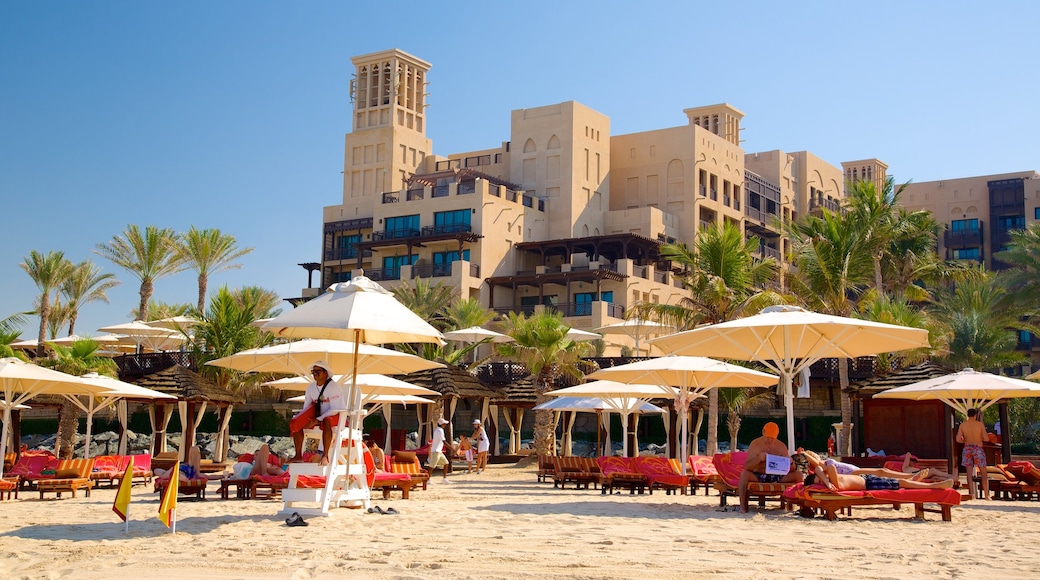 Souk Madinat Jumeirah which includes a beach, a luxury hotel or resort and tropical scenes