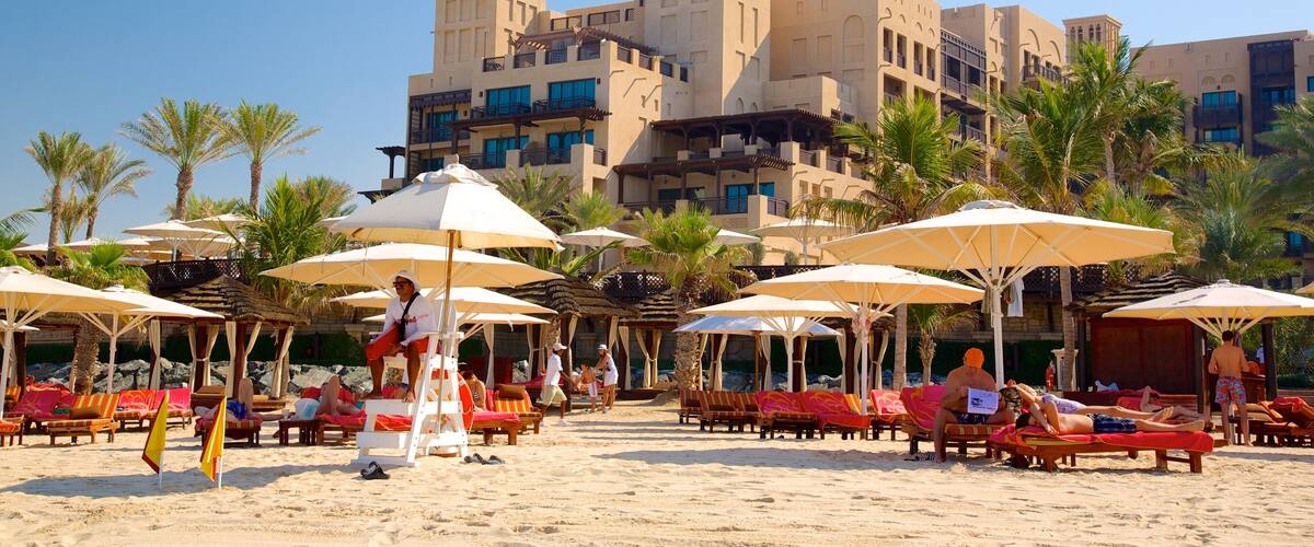Souk Madinat Jumeirah featuring a luxury hotel or resort, tropical scenes and a beach