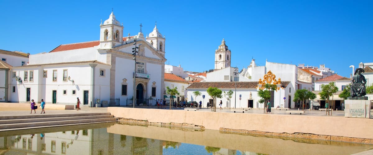 Algarve showing a church or cathedral, a small town or village and a pool
