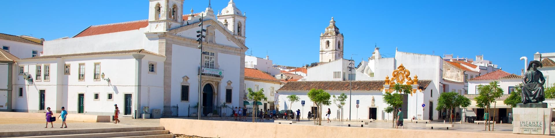 Algarve showing a church or cathedral, a small town or village and a pool