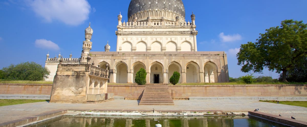 Qutub Shahi Tombs which includes heritage architecture, a pond and a temple or place of worship