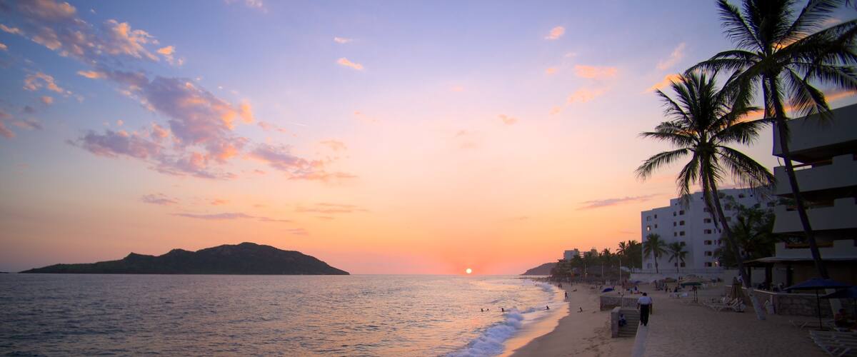 Mazatlán mostrando una ciudad costera, una playa de arena y una puesta de sol