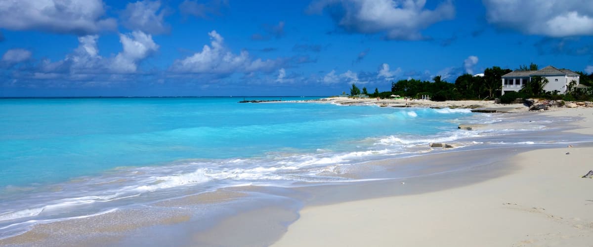 Grace Bay which includes a sandy beach, tropical scenes and a house