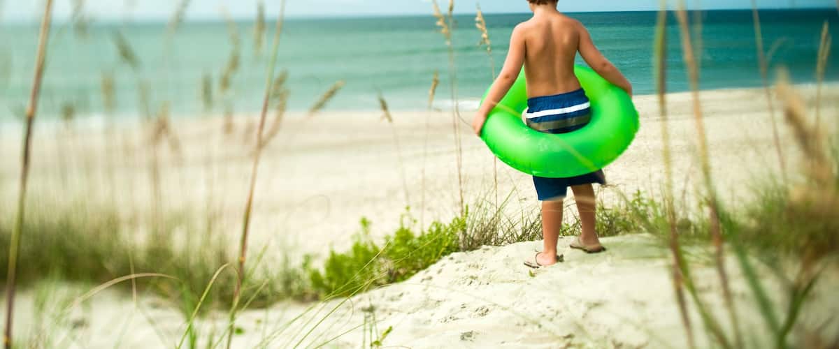 Morehead City featuring a sandy beach as well as an individual child