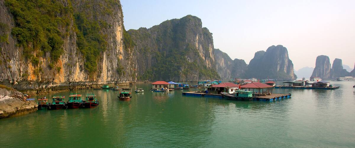 Halong Bay featuring a coastal town, rugged coastline and a gorge or canyon