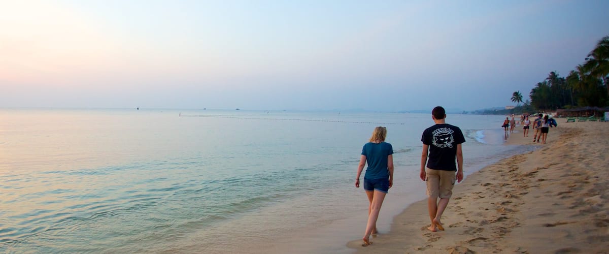 Phu Quoc Beach featuring a sandy beach and tropical scenes as well as a couple