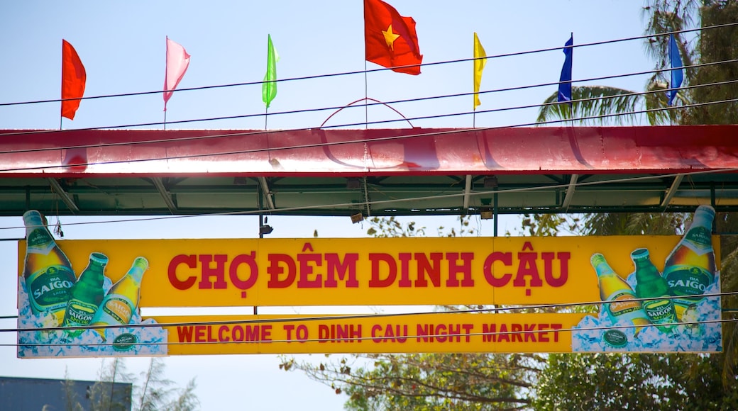 Dinh Cau which includes markets and signage