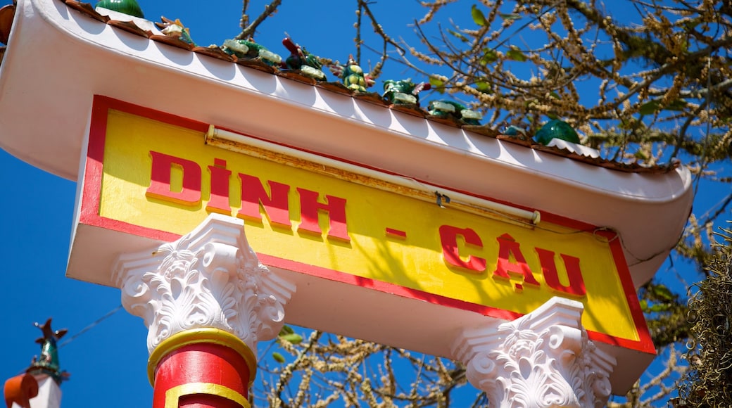 Dinh Cau Temple which includes a temple or place of worship, religious elements and signage