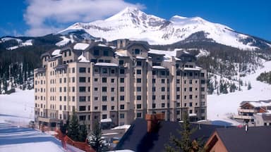 Big Sky showing mountains, a luxury hotel or resort and snow