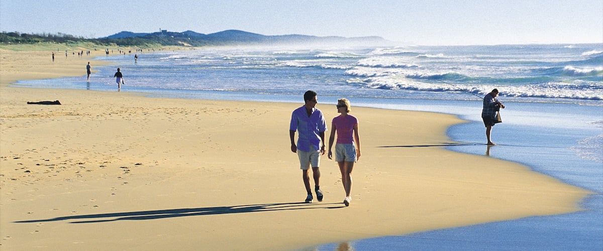 Coolum Beach showing a sandy beach and landscape views as well as a couple