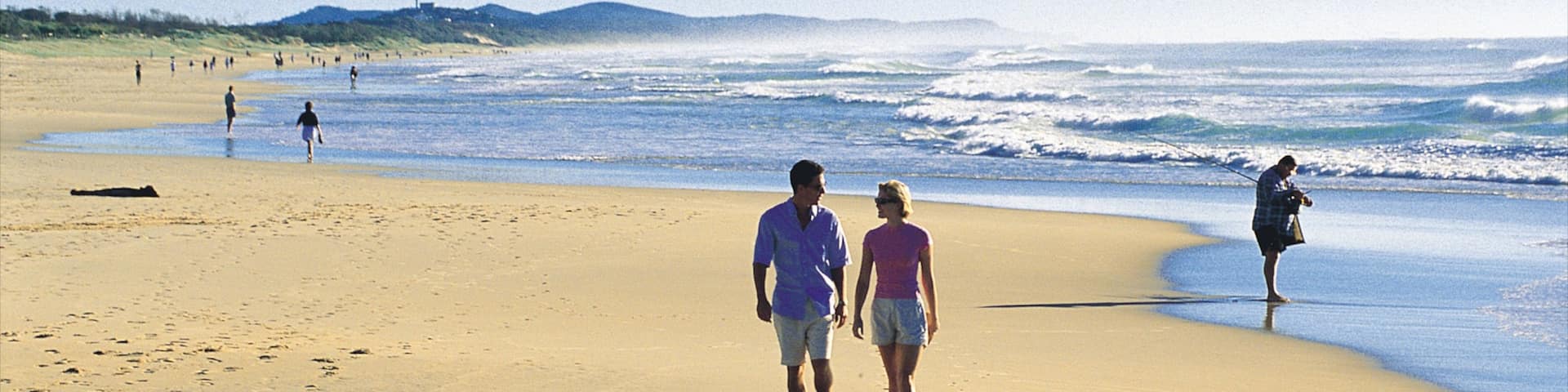 Coolum Beach showing a sandy beach and landscape views as well as a couple