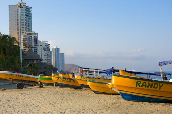 Rodadero Beach which includes a beach, a skyscraper and boating