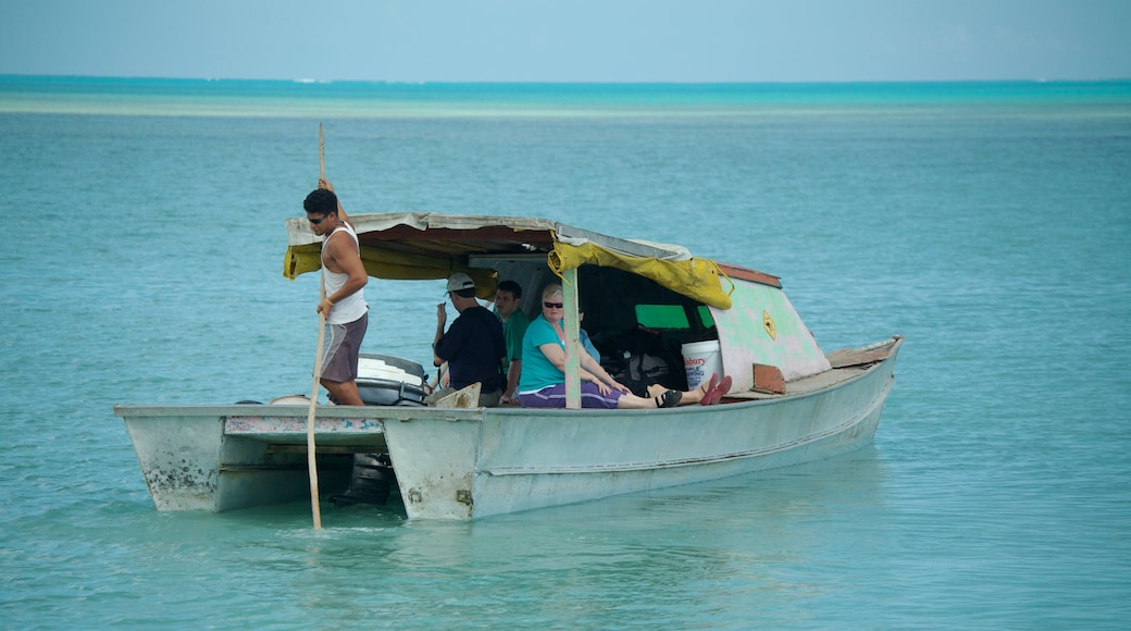 Manono showing tropical scenes and boating as well as a small group of people