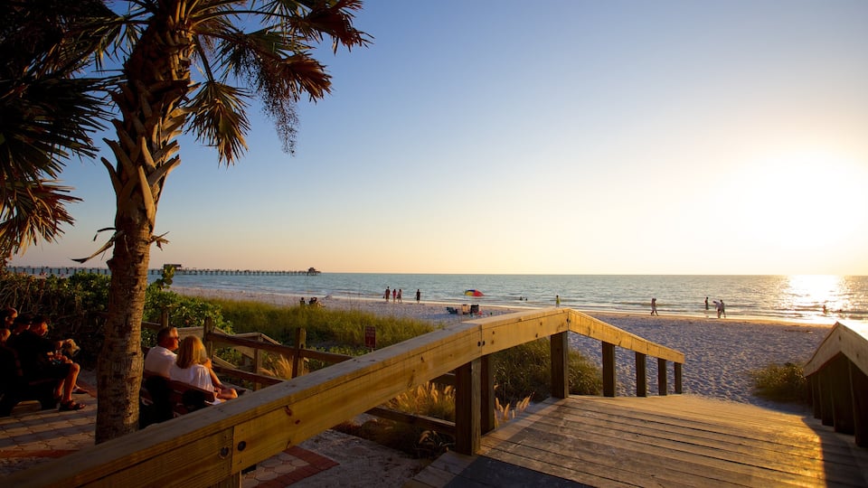Naples featuring a sandy beach and a sunset