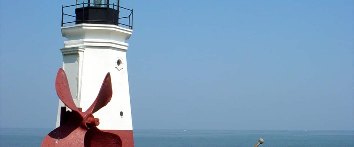 Sandusky which includes general coastal views and a lighthouse