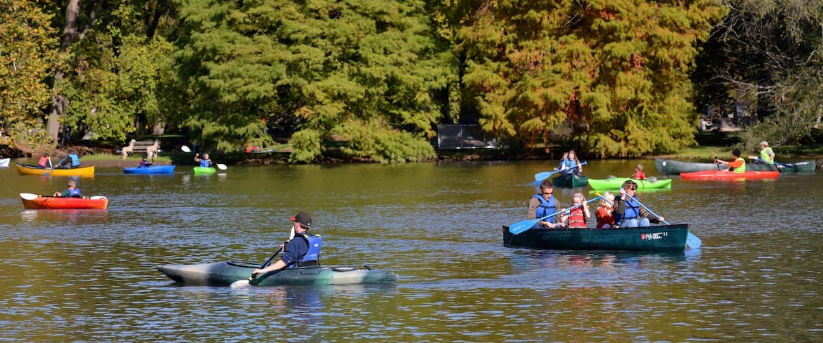 Dayton featuring a lake or waterhole and kayaking or canoeing as well as a small group of people