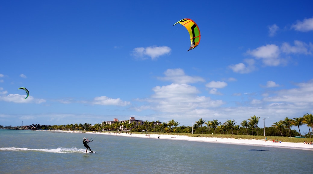 Smathers Beach featuring kite surfing and a sandy beach as well as an individual male