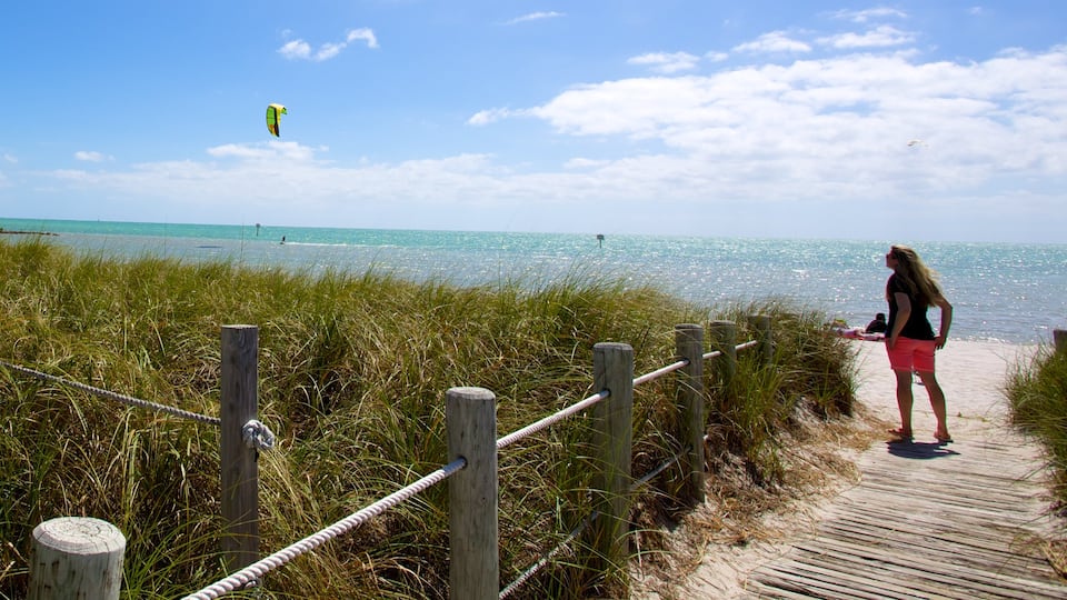 Smathers Beach which includes a bridge and a sandy beach as well as an individual female