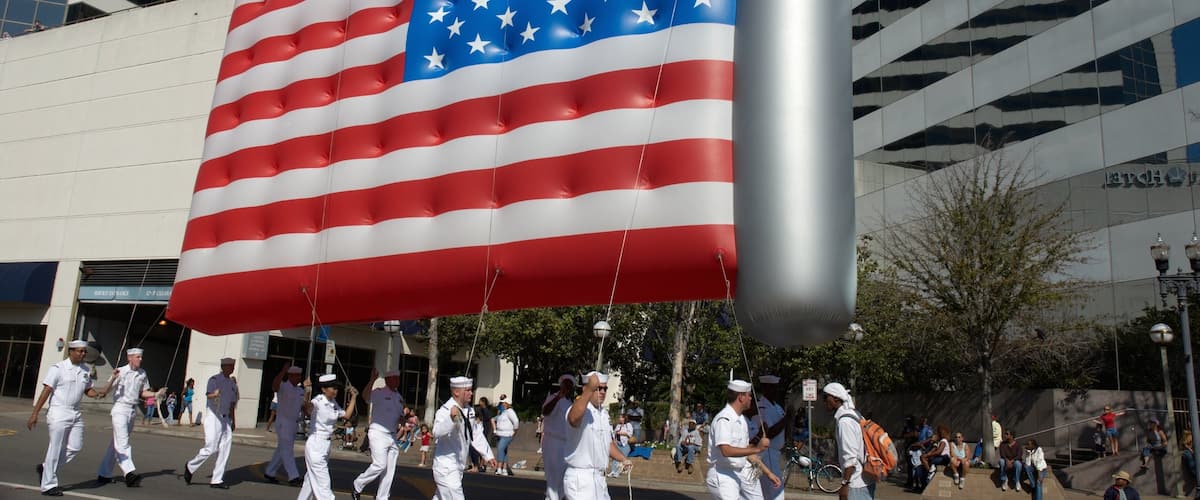 Downtown Jacksonville which includes a festival and military items as well as a large group of people