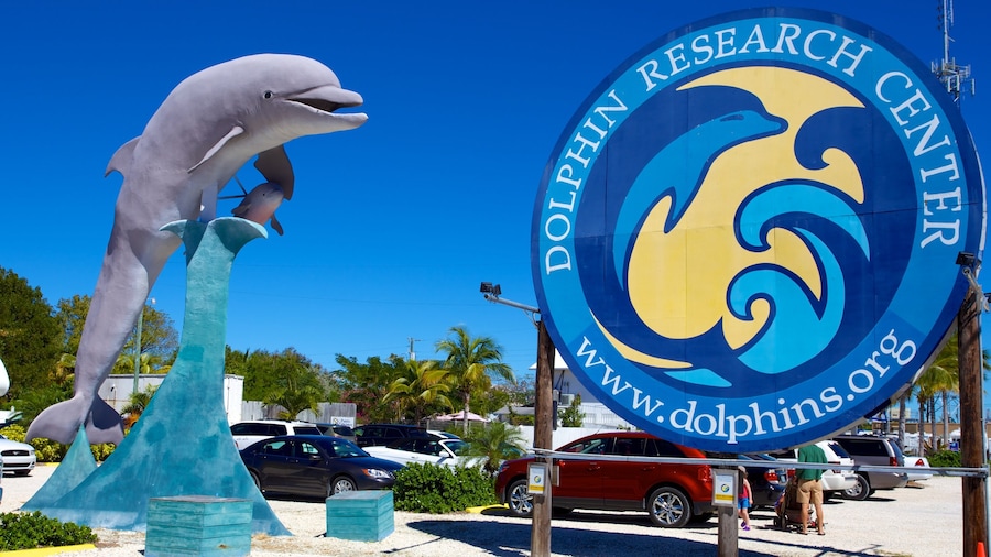 Dolphin Research Center which includes a statue or sculpture and signage
