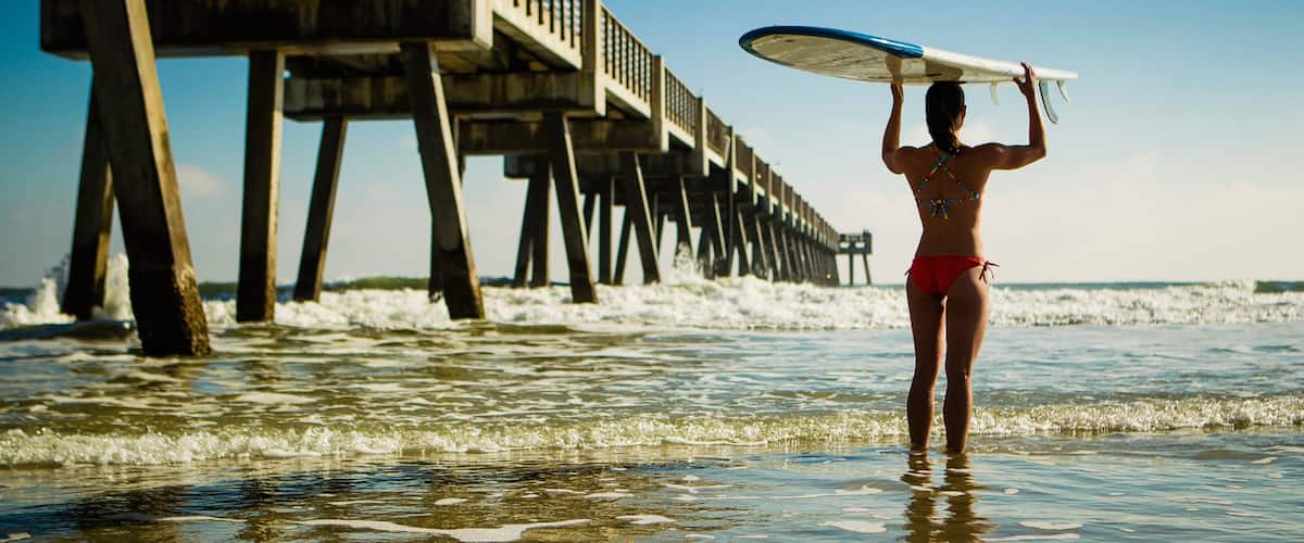 Jacksonville Beach Pier showing general coastal views as well as an individual female