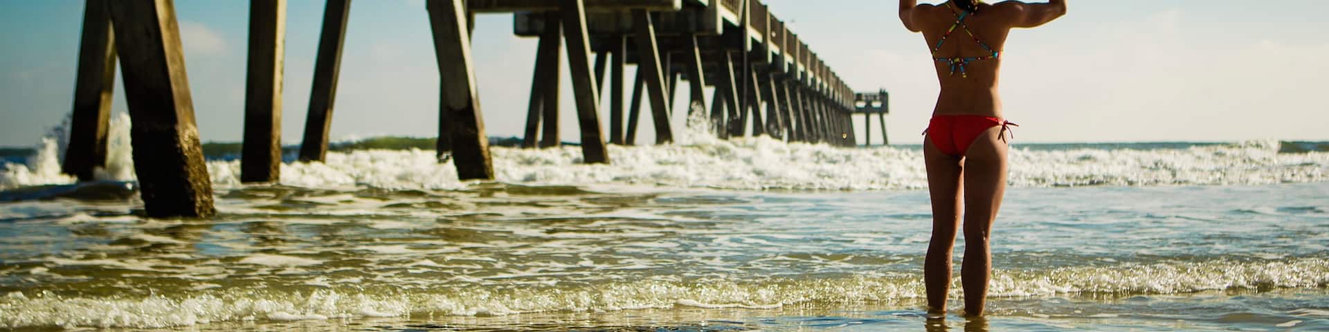 Jacksonville Beach Pier featuring general coastal views as well as an individual female