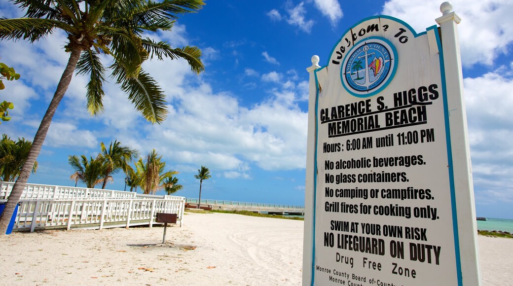 Higgs Beach featuring signage and a sandy beach