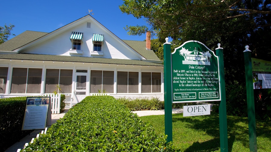 Naples Historical Society\'s Historic Palm Cottage featuring signage and a house