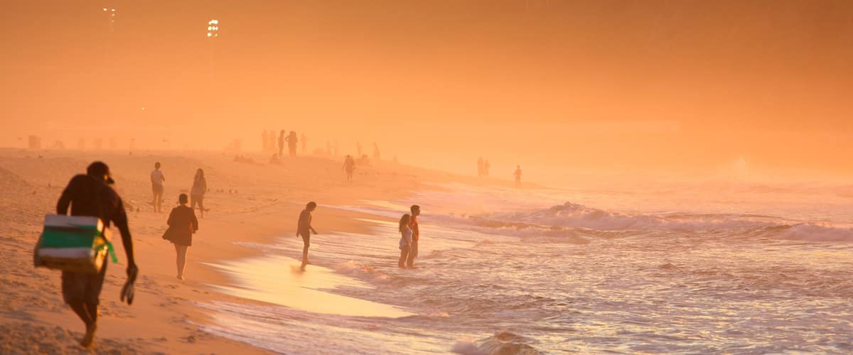 Copacabana Beach which includes mist or fog, a sunset and a sandy beach