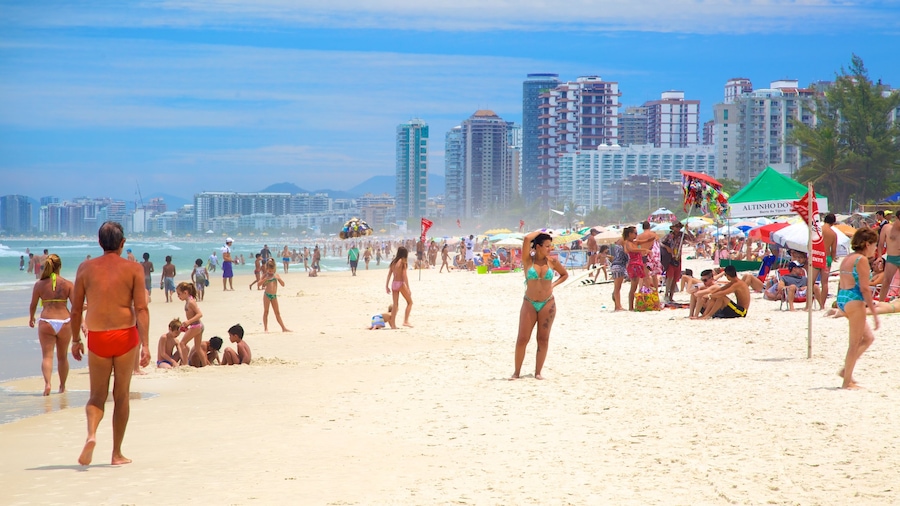Barra da Tijuca showing a sandy beach as well as a large group of people