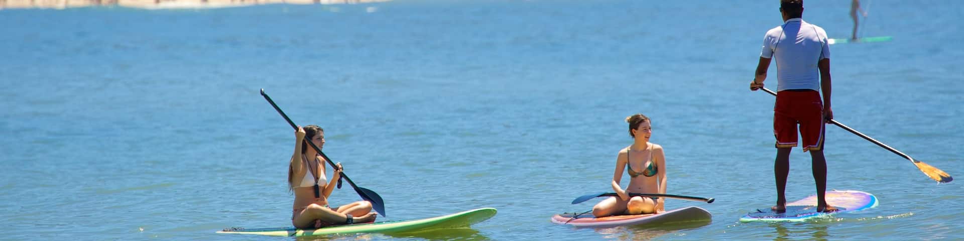Copacabana Beach showing water sports as well as a small group of people