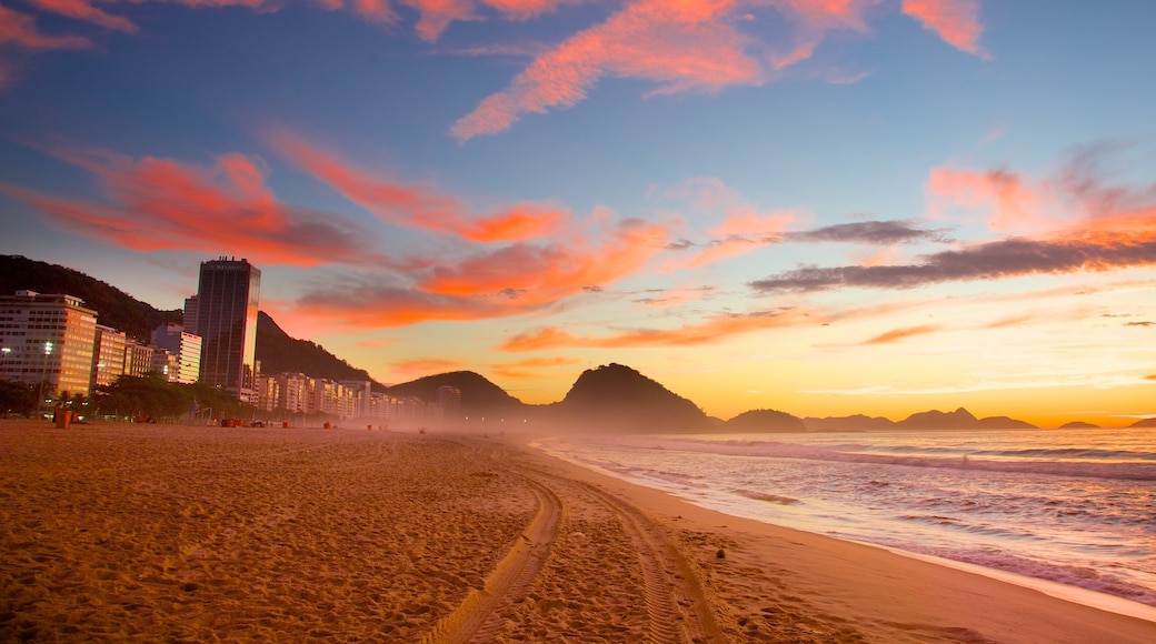 Copacabana Beach which includes a sandy beach, a sunset and general coastal views