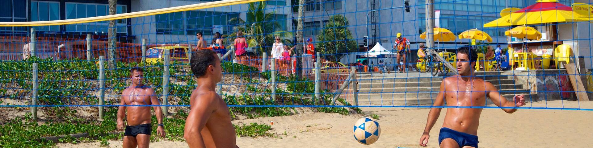 Ipanema Beach featuring a sandy beach as well as a small group of people